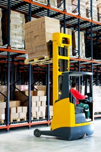 Yellow fork lifter with pallet in warehouse